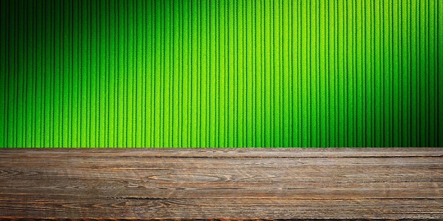 The background is blank wooden boards and a textured striped wall with gradient lighting