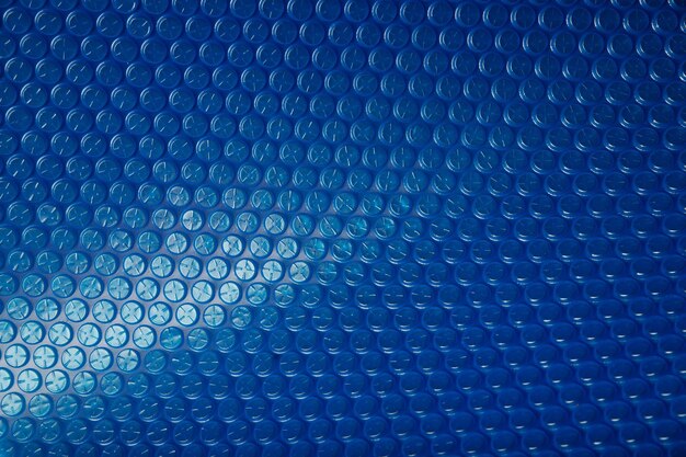 The background is blue with a transition to a blur. Polyethylene protection plastic waste.