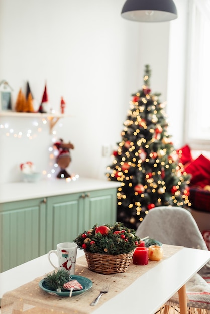 In Background is Christmas Tree with Bokeh Lights Christmas Background Kitchen Table Decorated