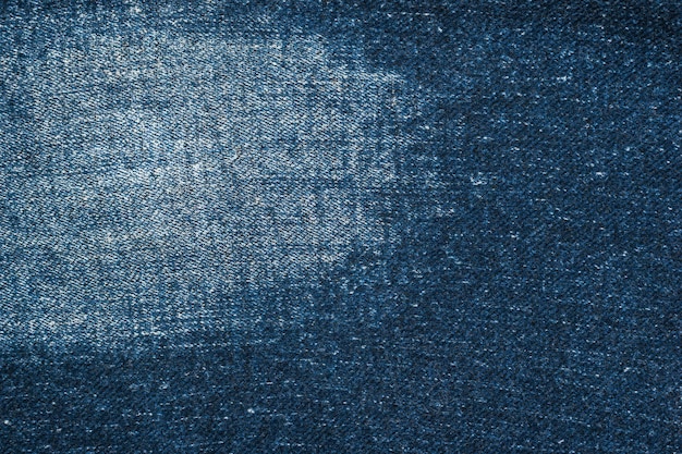 Photo the background is made of worn denim blue fabric