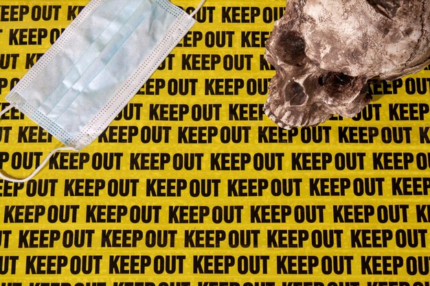 Background keep out distance warning sign with human skull and medical mask