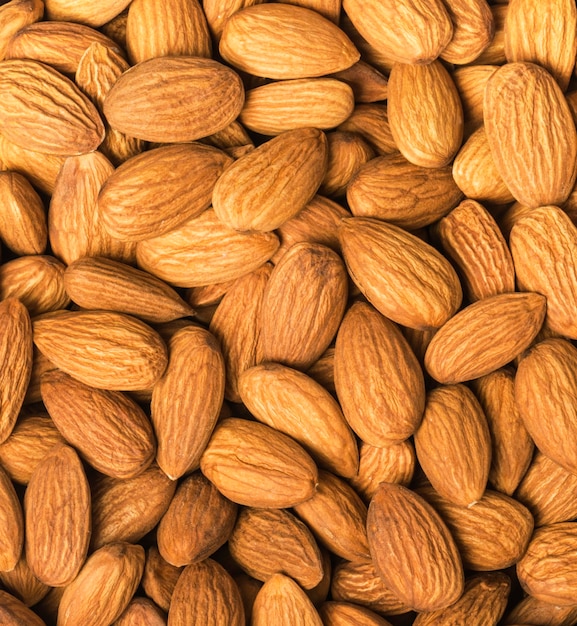 Background of large raw peeled almonds