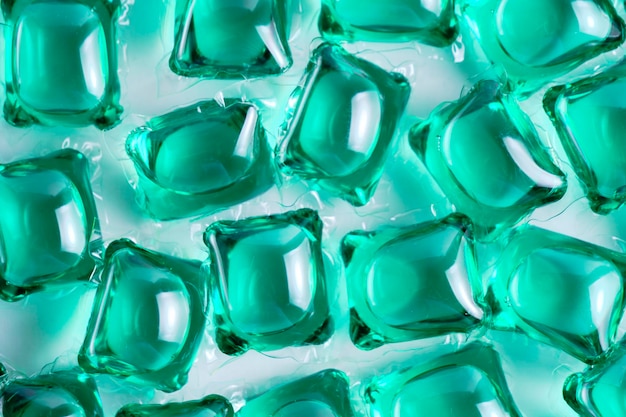 Background lot of capsules for washing green on light background