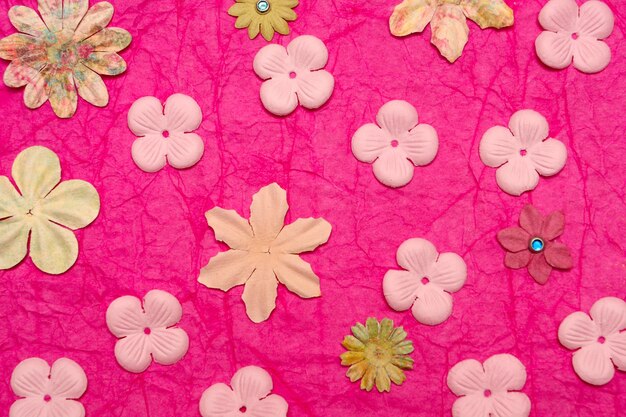 Background made of paper flowers in pink tones