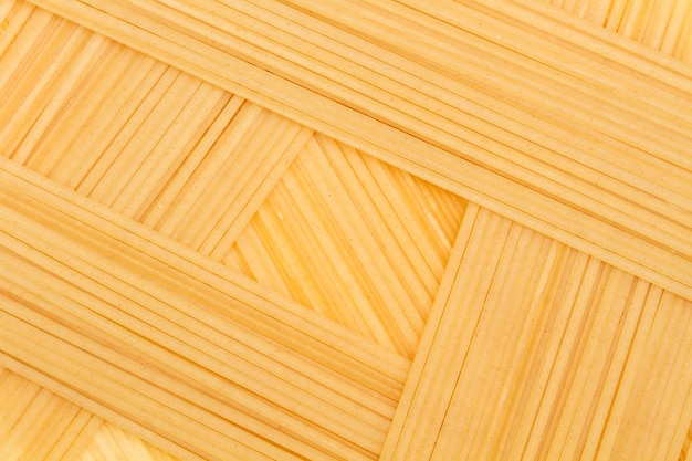 A background made with dry raw spaghetti in a close up view