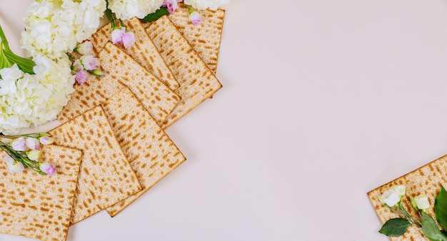 Background of matzah bread with flowers Jewish Passover holiday concept.