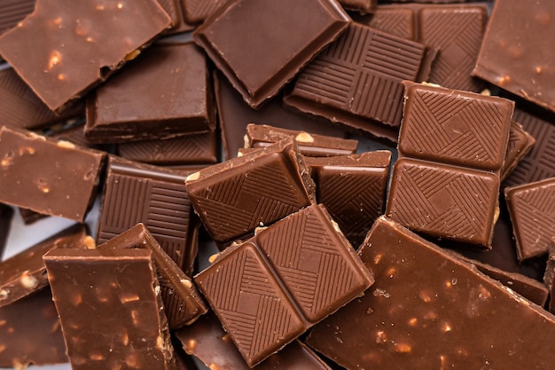 Background of milk chocolate pieces with nuts