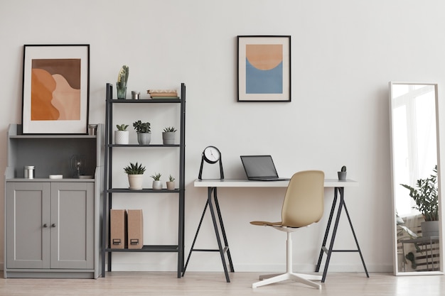 Photo background of minimal home office workplace in modern apartment decorated by plants and abstract art, copy space