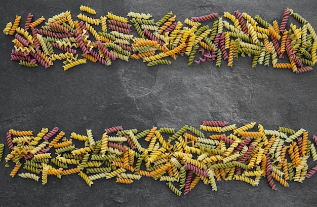 Background of multicolored pasta closeup top view