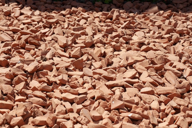 Background of natural grey granite crushed stone, macadam. Macro photo of texture of broken stone or rubble with place for text. Crushed rock. Construction Materials. Textures.