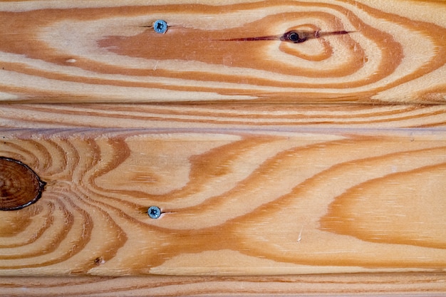 Background of natural wooden planks on the same surface with elements of knots