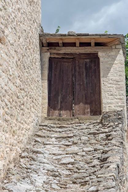 The background old beige stony wall with door