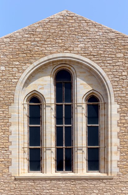 The background old beige stony wall with marble window