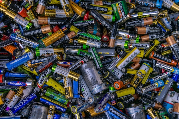 background  old used discarded AA cells and other electric batteries