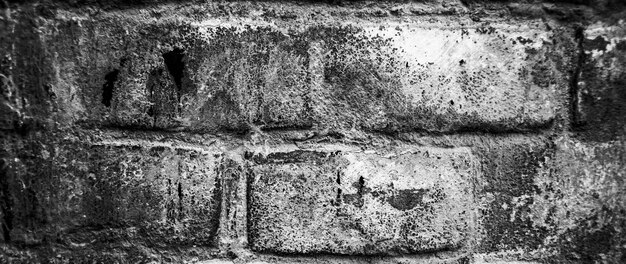 Background of old vintage dirty brick wall with peeling plaster, texture