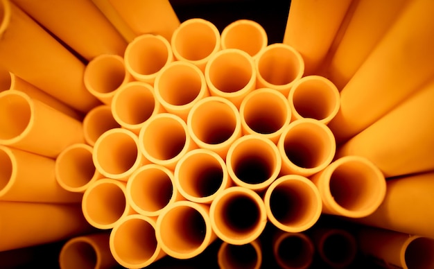 Background of the orange plastic pipes in stacked