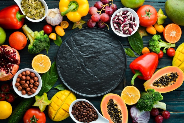 Background Organic food Fruits vegetables beans and nuts on a blue background Top view Free space for your text