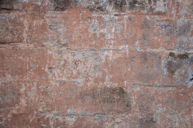 background, part of the old wall, from which the paint is peeling, the color of the wall is brown with small blue bald spots