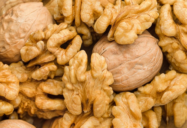 Background of peeled and unpeeled walnut top view