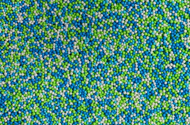 Immagine di sfondo di una varietà di polvere smaltata colorata sotto forma di piccole palline