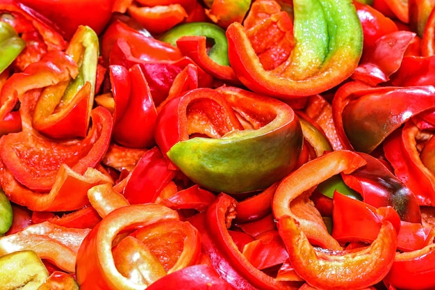 Photo background of the pieces of ripe chopped peppers