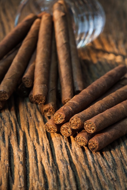 background, pile of small cigar on old wooden table