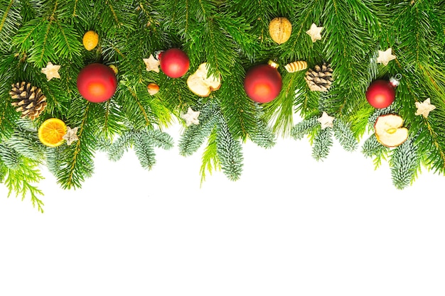 A background of pine branches with christmas decorations. Taken in Studio with a 5D mark III.