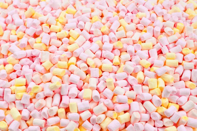 Background of pink and yellow colorful mini marshmallows