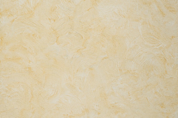 Fondo della texture intonacata con effetto marmo colore oro. background artistico fatto a mano