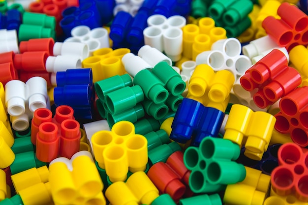 Background of plastic colored details building blocks Parts of bright small spare parts for toys