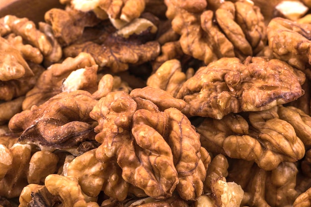 Photo background of raw peeled large nuts closeup.