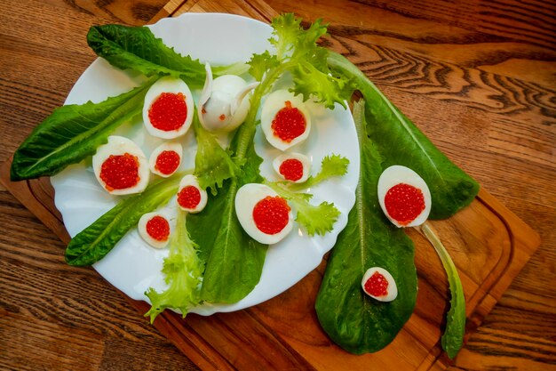 Background of red caviar on dsrk wooden surface tartlets with red caviar