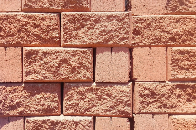 Background of red spliter brick block with torn edge