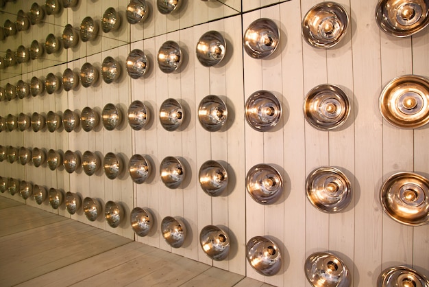 Photo background of round lamps on a wooden wall, reflected repeatedly in the mirrors