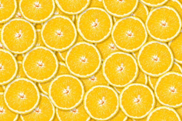 Background of round slices of yellow oranges