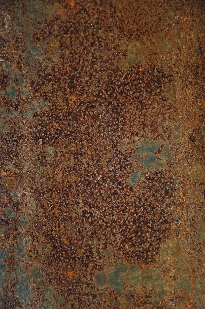Photo background of rust on metal textured brown with orange color spots bluish tint