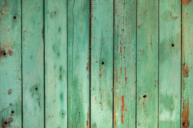 Background screensaver from old green boards Old fence with cracked green paint Place for an inscription Copy space