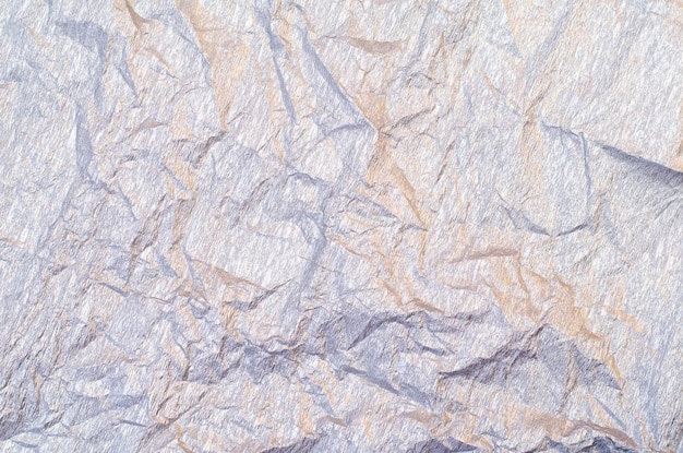 Background of silver and golden wrinkled crepe tissue paper