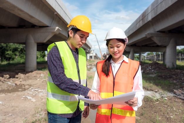 In the background, skyscraper concrete formwork frames, and a portrait of a confident female construction worker at a construction site.