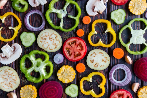 Background of sliced fresh vegetables on a wooden background