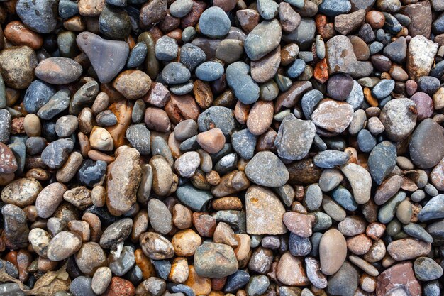 Background of small pebbles and stones on the seashore or in garden