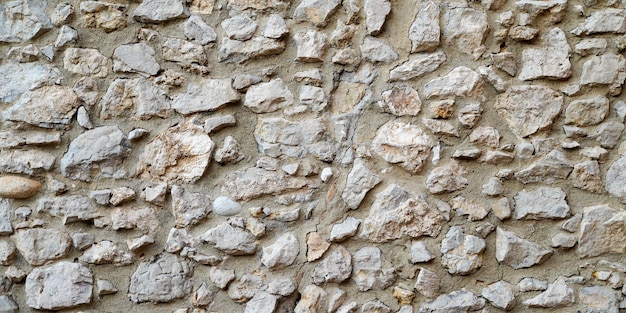 Background stones hands made wall restoration facade wall stone wallpaper in web header panorama