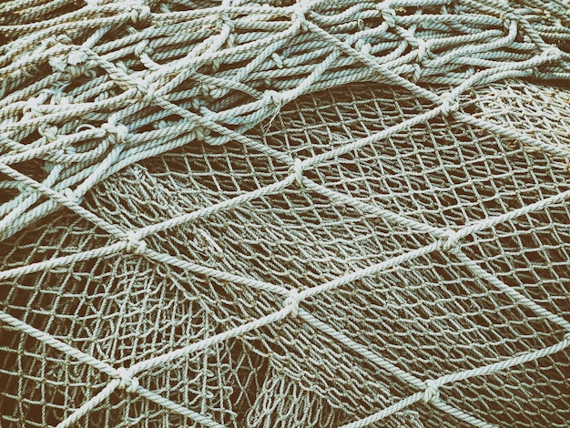 Photo background of tangled fishing nets, toned.