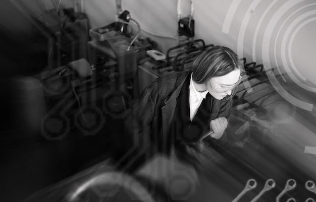 Background technological young woman engineer working on a machine