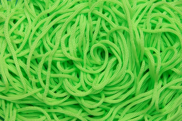 Background of textile cords of bright green color.