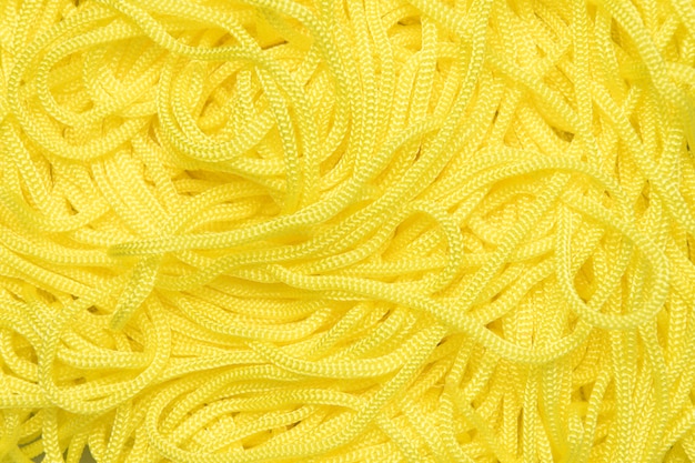 Background of textile cords of yellow color