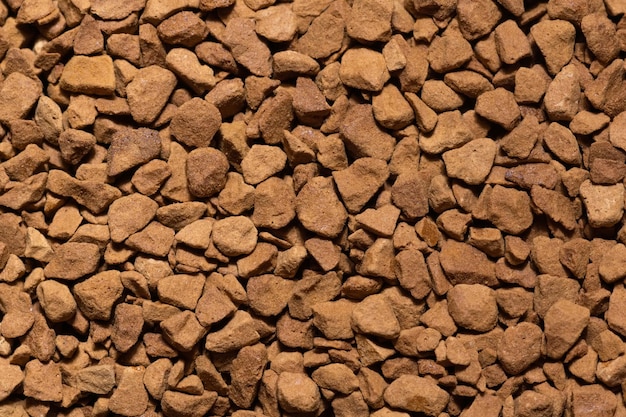 Background and texture of arabica instant coffee granules close-up macro