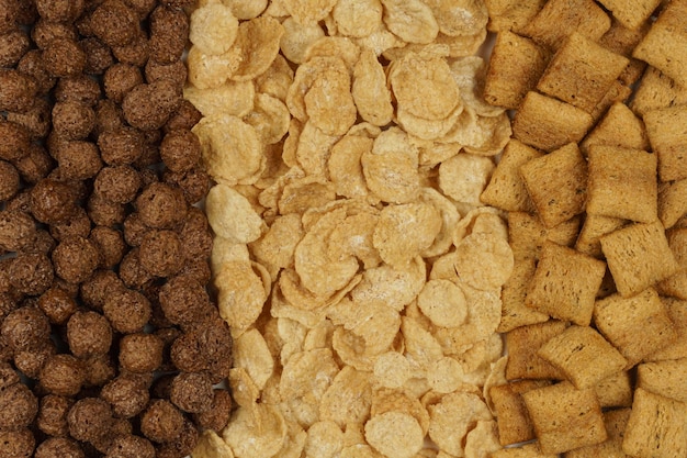 Background and texture of breakfast cereals corn flakes chocolate balls pads