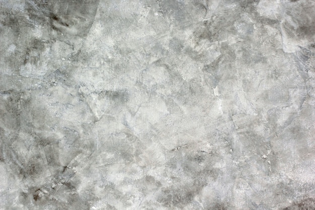 The background texture of the cement plaster is raw white and gray.