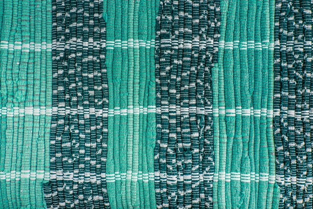 background, texture of colored handmade carpet. fabric rug of small patches